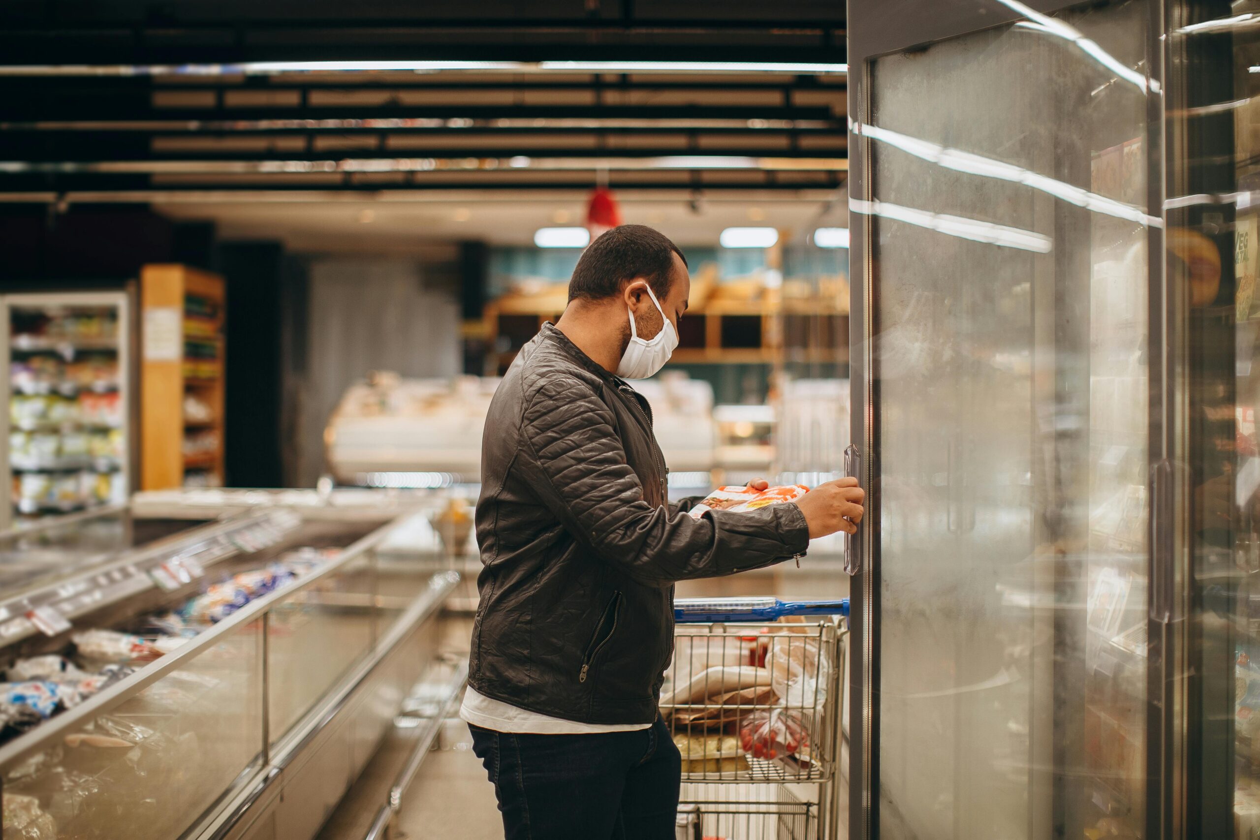 Man in Jacket Opening Fridge in Supermarket